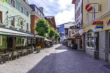 View of restaurants and cafes and street scene in Zell am See on a sunny day, Zell am See, Salzburg, Austria, Europe