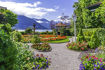 View of garden overlooking Lake Zell in Zell am See on a sunny day, Zell am See, Salzburg, Austria, Europe