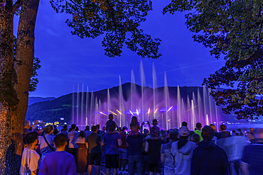 View of Wasserspiele, water fountains show on Lake Zell at dusk, Zell am See, Salzburg, Austria, Europe