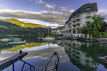 View of The Grand Hotel, mountains and Lake Zell during golden hour, Zell am See, Salzburg, Austria, Europe