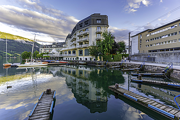 View of The Grand Hotel, mountains and Lake Zell during golden hour, Zell am See, Salzburg, Austria, Europe