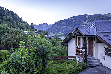 View of chalet in Zell am See and mountains in backgroundd during golden hour, Zell am See, Salzburg, Austria, Europe