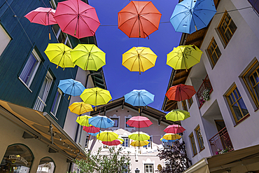 View of colourful umbrellas in Zell am See on a sunny day, Zell am See, Salzburg, Austria, Europe