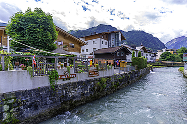 View of river running through the town of Kaprun on a sunny day, Kaprun, Salzburg, Austria, Europe