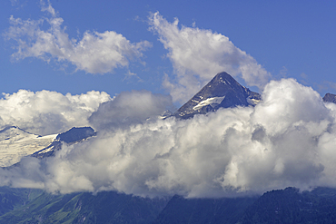 View of mountains toward Grossglockner from Plettsaukopf Reservoir on a sunny day, Bruckberg, Salzburg, Austria, Europe