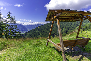View of Kaprun and mountains toward Grossglockner from Plettsaukopf Reservoir on a sunny day, Bruckberg, Salzburg, Austria, Europe