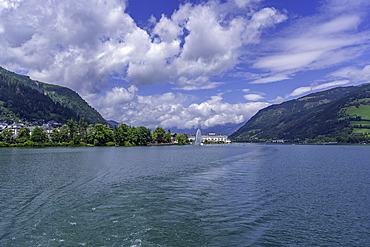 View of the Grand Hotel and Lake Zell in Zell am See from tour boat on a sunny day, Zell am See, Salzburg, Austria, Europe