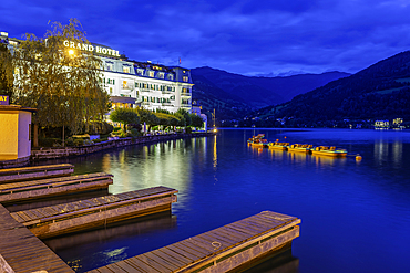 View of the Grand Hotel overlooking Lake Zell in Zell am See at dusk, Zell am See, Salzburg, Austria, Europe