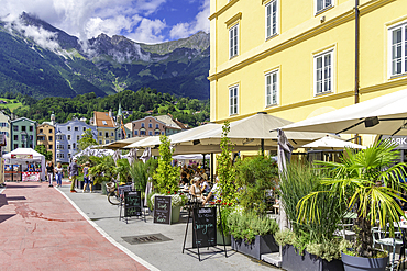 View of restaurant and colourful buildings and River Inn on a sunny day in summer, Innsbruck, Tyrol Region, Austria, Europe
