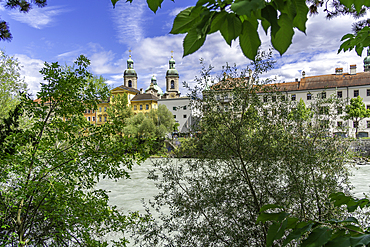 View of St. Jakob Cathedral, colourful buildings and River Inn on a sunny day in summer, Innsbruck, Tyrol Region, Austria, Europe