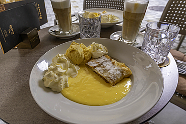 View of apple strudel and cream in the old town of Innsbruck, Innsbruck, Tyrol Region, Austria, Europe