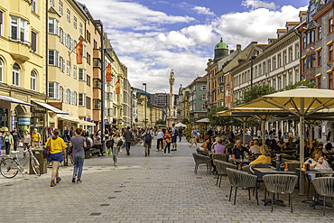View of cafes in the town square and Annasäule in the old town of Innsbruck on a sunny day in summer, Innsbruck, Tyrol Region, Austria, Europe