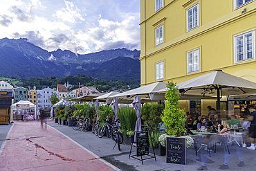 View of restaurant and colourful buildings and River Inn at sunset in summer, Innsbruck, Tyrol Region, Austria, Europe
