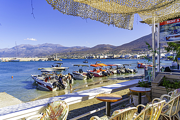 View of boats and small beach in Port of Hersonissos, Limenas Chersonisou, Crete, Greek Islands, Greece, Europe