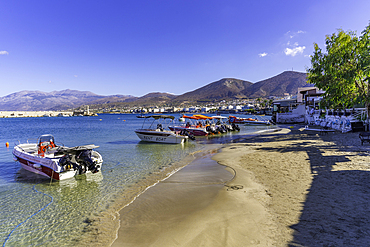 View of boats and small beach in Port of Hersonissos, Limenas Chersonisou, Crete, Greek Islands, Greece, Europe