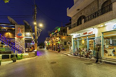 View of shop and taverna's in Piskopiano village at dusk, Piskopiano, Crete, Greek Islands, Greece, Europe