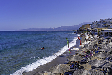View of sunshades on Limena Chersonisou Beach, Limenas Chersonisou, Crete, Greek Islands, Greece, Europe