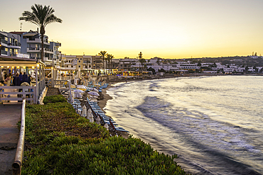 View of Palmowy Zakątek Beach at sunset, Limenas Chersonisou, Crete, Greek Islands, Greece, Europe