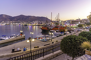 View of boats in Port of Limenas Chersonisou at dusk, Limenas Chersonisou, Crete, Greek Islands, Greece, Europe