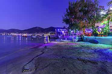 View of taverna and small beach at Port of Limenas Chersonisou at dusk, Limenas Chersonisou, Crete, Greek Islands, Greece, Europe