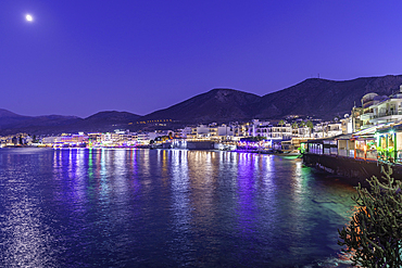 View of coastline and Paralia Limena Chersonisou Beach in Limenas Chersonisou at dusk, Crete, Greek Islands, Greece, Europe