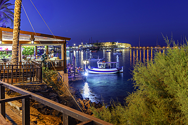View of taverna and Port of Limenas Chersonisou at dusk, Limenas Chersonisou, Crete, Greek Islands, Greece, Europe