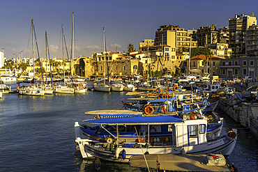 View of boats in Heraklion Venetian Port at sunset, City of Heraklion, Crete, Greek Islands, Geece, Europe