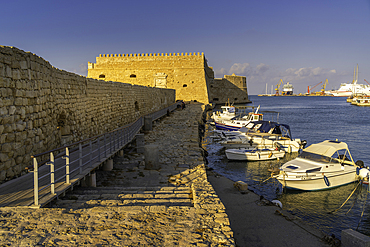 View of Koules Venetian Fortress and boats in Heraklion Venetian Port at sunset, City of Heraklion, Crete, Greek Islands, Geece, Europe