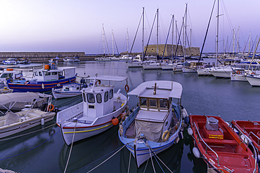 View of Koules Venetian Fortress and boats in Heraklion Venetian Port at dusk, City of Heraklion, Crete, Greek Islands, Geece, Europe