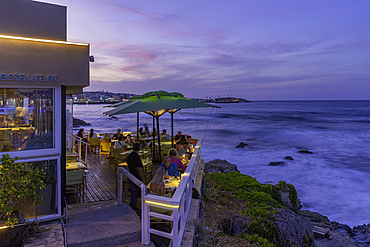 View of taverna overlooking the sea in Limenas Chersonisou at dusk, Crete, Greek Islands, Greece, Europe