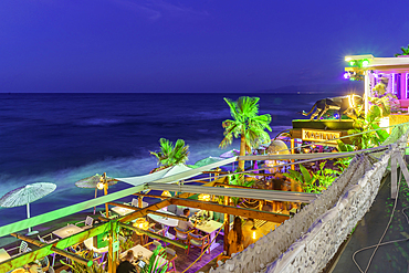View of taverna overlooking the sea in Limenas Chersonisou at dusk, Crete, Greek Islands, Greece, Europe