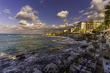 View of taverna overlooking the sea in Limenas Chersonisou at sunset, Crete, Greek Islands, Greece, Europe
