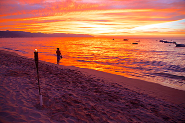 Torch and couple on the beach in Downtown at sunset, Puerto Vallarta, Jalisco, Mexico, North America