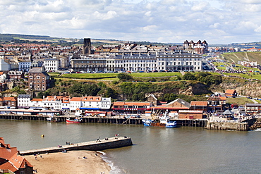 Tate Hill Pier and the West Cliff with St. Hilda's Church, Whitby, Yorkshire, England, United Kingdom, Europe