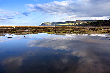 Cloud reflections in a tide pool at Robin Hoods Bay, Yorkshire, England, United Kingdom, Europe