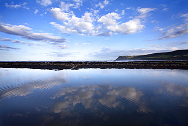 Cloud reflections in a tide pool at Robin Hoods Bay, Yorkshire, England, United Kingdom, Europe