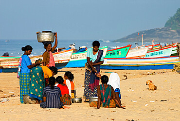 Local women buying freshly caught fish, Chowara Beach, near Kovalam, Kerala, India, Asia