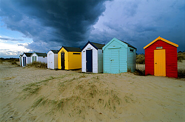 Beach huts under stormy sky, Southwold, Suffolk, England, United Kingdom, Europe