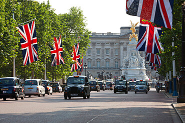 Buckingham Palace with taxis and Union Jacks along The Mall, London, England, United Kingdom, Europe