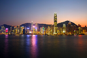 View over Victoria harbour to Hong Kong Island and The Peak at dusk, Hong Kong, China, Asia