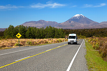 Motorhome below Mount Ngauruhoe with Kiwi crossing sign, Tongariro National Park, UNESCO World Heritage Site, North Island, New Zealand, South Pacific