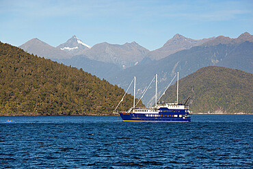 Fiordland Navigator cruise boat and Coronation Peak, Doubtful Sound, Fiordland National Park, UNESCO World Heritage  Site, South Island, New Zealand, Pacific