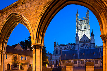 Gloucester Cathedral viewed through the Infirmary Arches at night, Gloucester, Gloucestershire, England, United Kingdom, Europe