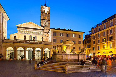 Baroque fountain and Santa Maria in Trastevere at night, Piazza Santa Maria in Trastevere, Rome, Lazio, Italy, Europe