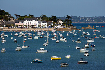 View over seaside village and boats in bay, Locquirec, Finistere, Brittany, France, Europe