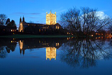 Tewkesbury Abbey reflected in water at dusk, Tewkesbury, Gloucestershire, England, United Kingdom, Europe