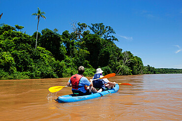 Kayaking on the Iguazu River past sub-tropical rainforest, near Andresito, Iguazu National Park, Misiones Province, Argentina, South America