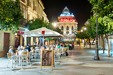 Night view of cafes along Calle Lanceria and El Gallo Azul rotunda building, Jerez de la Frontera, Andalucia, Spain, Europe