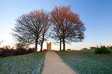 Broadway Tower framed by trees in winter frost at sunrise, Broadway, Cotswolds, Worcestershire, England, United Kingdom, Europe