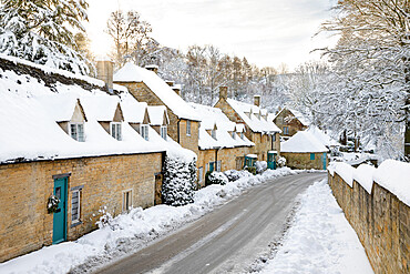 Line of Cotswold stone cottages covered in winter snow, Snowshill, Cotswolds, Gloucestershire, England, United Kingdom, Europe